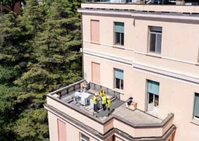 Operai su un terrazzo ai piani alti del Padiglione Specialità durante l'intervento sismico ISAAC